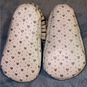 White shoes with glitter hearts.